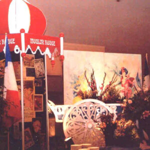 A Moulin Rouge Tower with Flower Cart in the middle of a table.