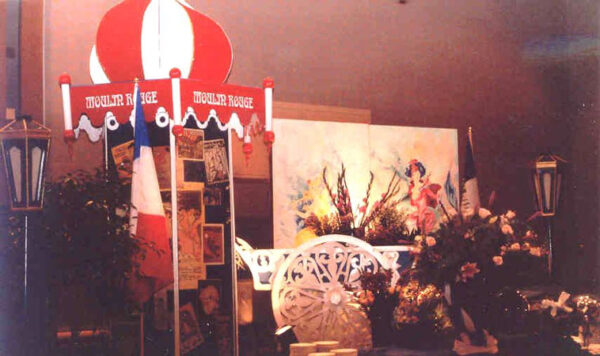 A Moulin Rouge Tower with Flower Cart in the middle of a table.