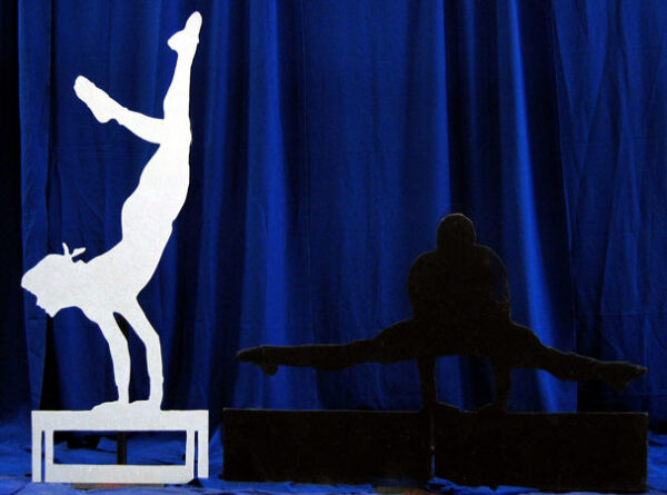 Two silhouettes of a person doing a handstand at the Olympic Games.