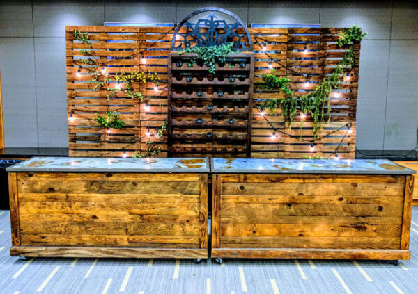 An Outdoor Bar and Pallet Wood Wall with plants on it.