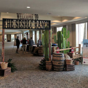 A hallway with cactus signs and barrels.