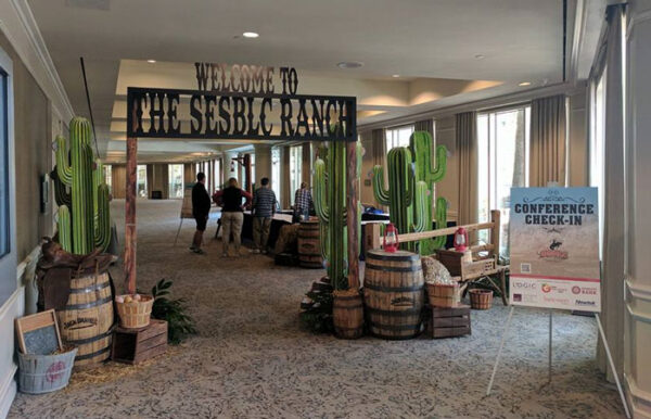 A hallway with cactus signs and barrels.