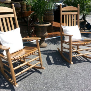 Two Rocking Chairs in a parking lot.