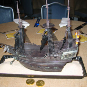 A cake with a Ship Table Centerpieces on it.