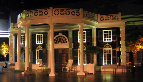 A white building with pillars.