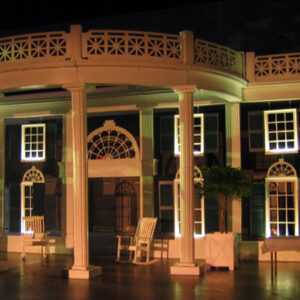 A white Southern Mansion and Garden with pillars.