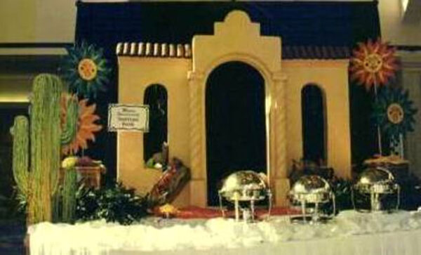 A Mexican themed party with a Mexican Building Buffet in the middle.