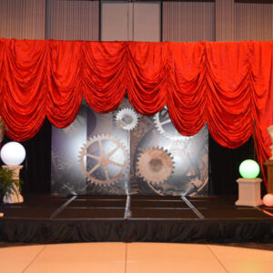 A stage with red drapes and lights.