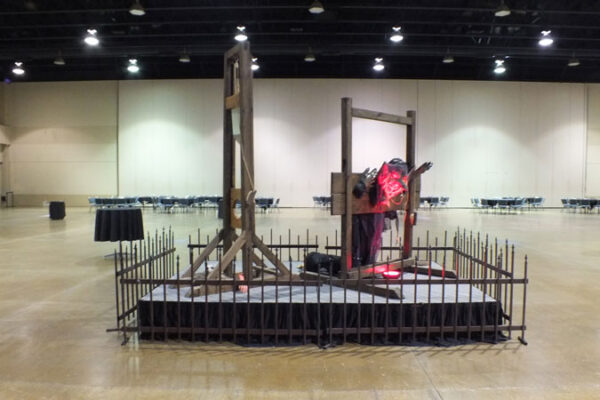 A large room with a display of the Guillotine.