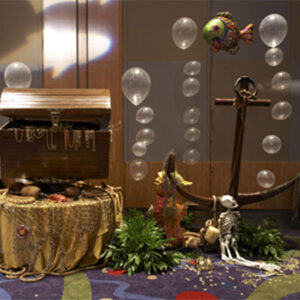 A pirate themed party with balloons and a {Treasure Chest}.