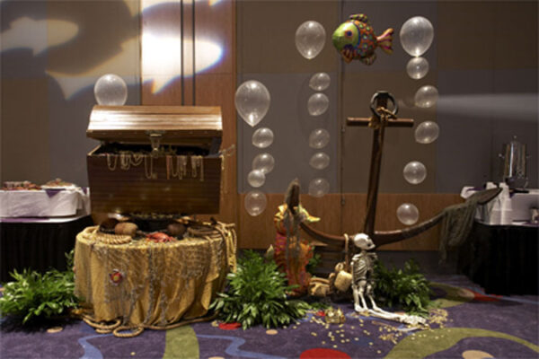 A pirate themed party with balloons and a {Treasure Chest}.