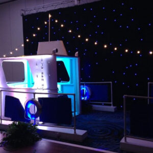 A photo booth with Tug Boat Set lights and a Tug Boat Set backdrop.