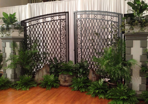 A Tuilerie Gardens gate with plants in front of it.