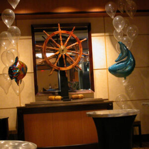 A room filled with balloons and a Captain's Wheel.