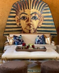 A living room with King Tut's Head (Cutout) on the wall.