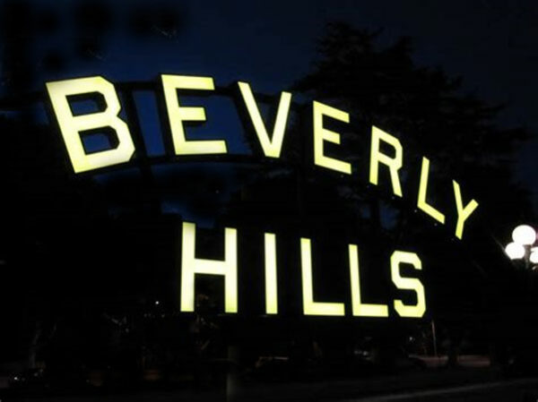 The Beverly Hills Sign is lit up at night.