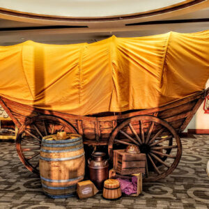 A Chuck Wagon in a room with barrels and barrels.