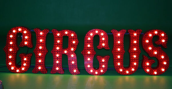 A red led sign with Block Letters on it.