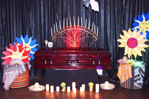 Caskets decorated with flowers and candles.