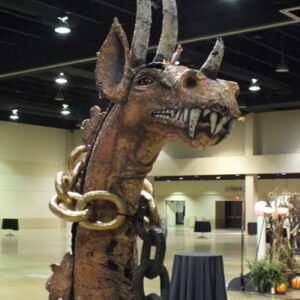 A large casket of a dragon in a convention hall.