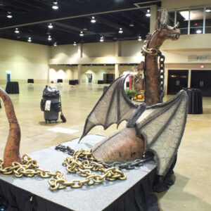 A large statue of a casket in a convention hall.