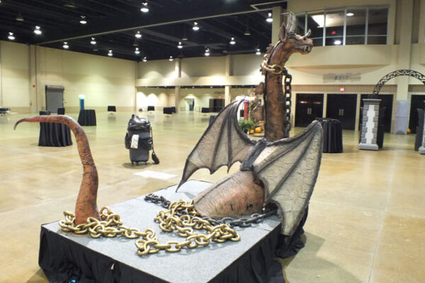 A large statue of a casket in a convention hall.