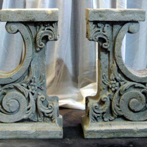 A pair of Decorative Pedestals on a table.