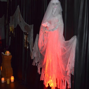 A casket dressed in a white dress is sitting on a table.