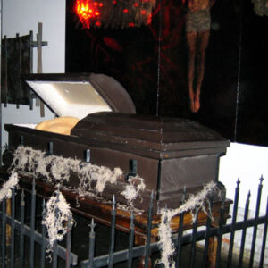 A black Caskets with a picture of jesus on it.