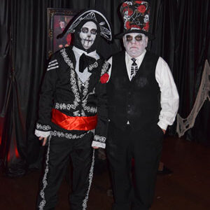 Two men dressed as caskets standing next to each other.