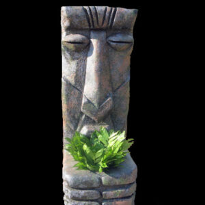 A statue of African Tiki Gods with a plant in it.