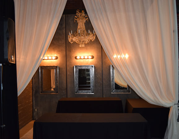 A stunning chandelier illuminating a table in a Photoshoot Studio setting.