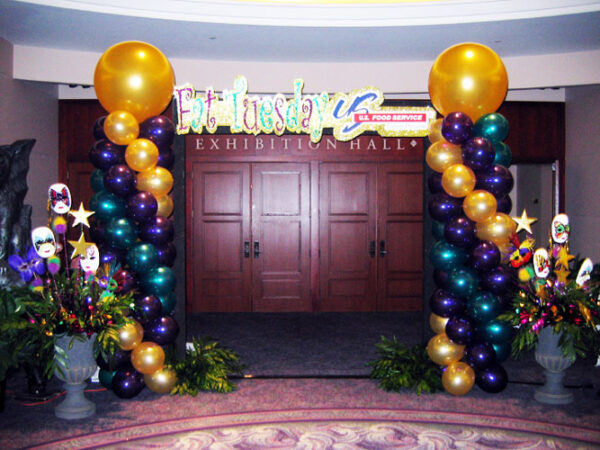 A Mardi Gras Entrances arch decorated for mardi gras.