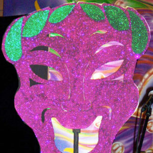 A Mardi Gras Jester with a green face.