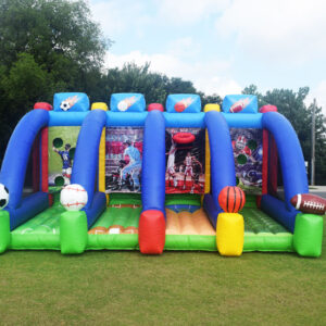 An inflatable bounce house with soccer balls and other toys.