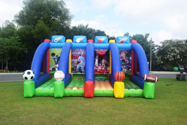 An inflatable bounce house with soccer balls and other toys.