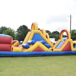 An inflatable obstacle course on a grassy field featuring an Inflatable Games.