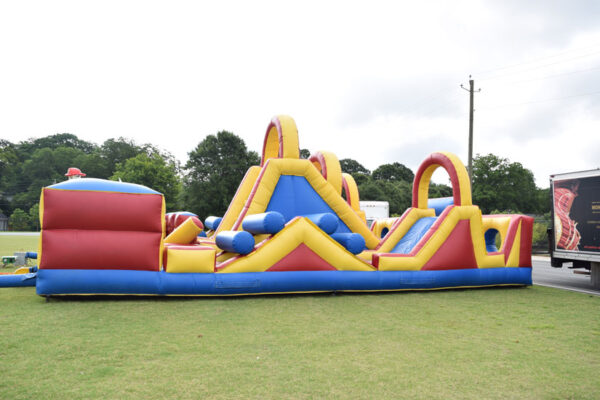 An inflatable obstacle course on a grassy field featuring an Inflatable Games.