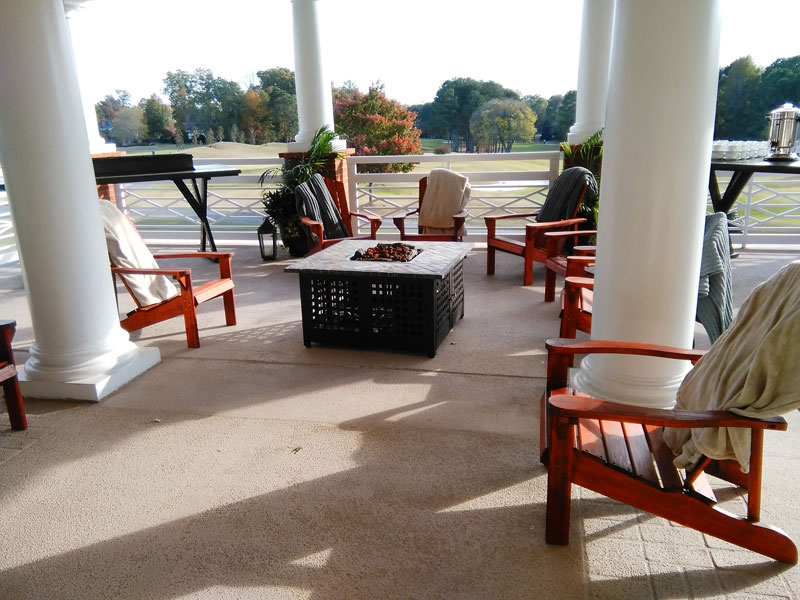 An outdoor patio with comfortable chairs and a fire pit, perfect for Event Furniture Rental.