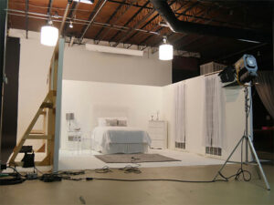 A white room with a bed and a ladder.