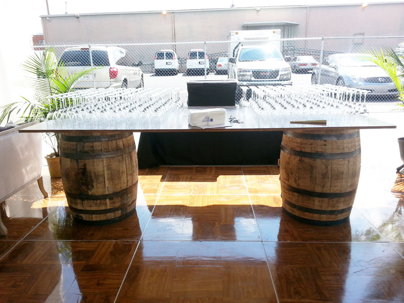 An event table with wine barrels on it.