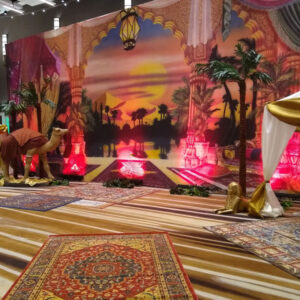 A room decorated with a rug and an Arabian Vignette.