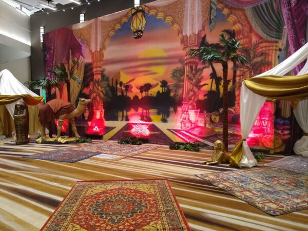 A room decorated with a rug and an Arabian Vignette.