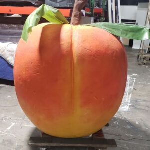 A Giant Atlanta Peach sitting on a pallet in a warehouse.