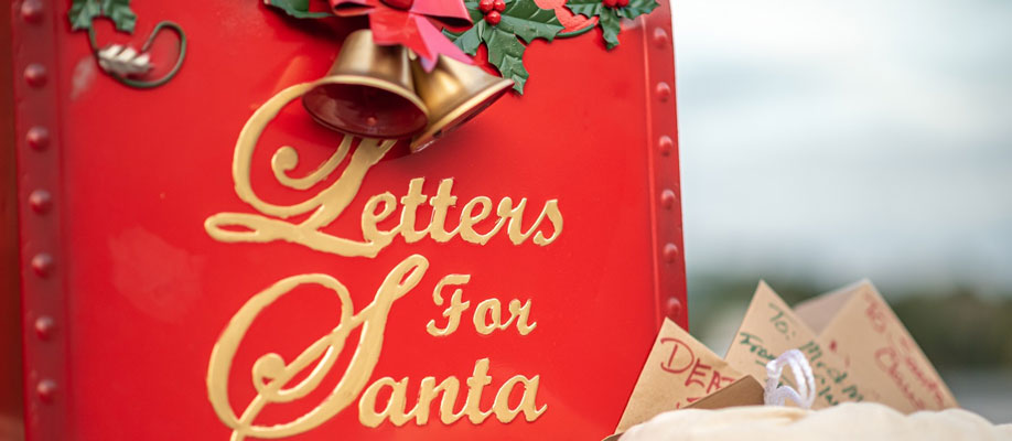 Letters for santa on a red mailbox.