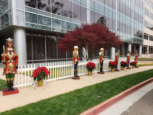 A group of nutcracker statues in front of a building.