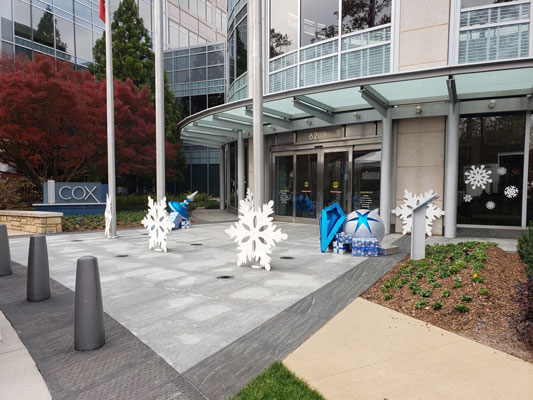 Snowflake decorations in front of a building.