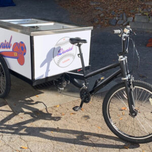 A Beverage Pedal Bike with an ice cream cart on it.