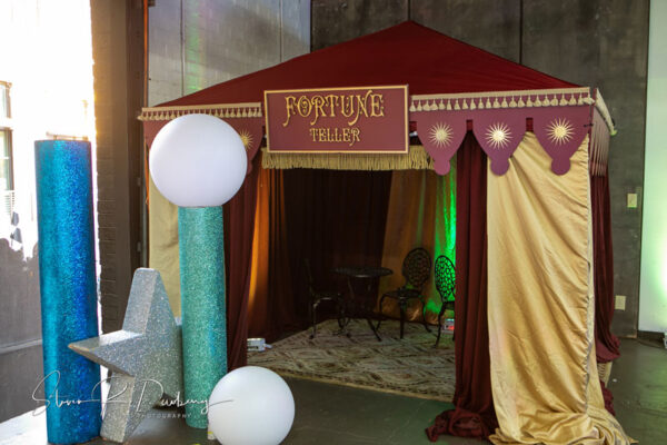 A Fortune Teller Tent set up with balloons and decorations.