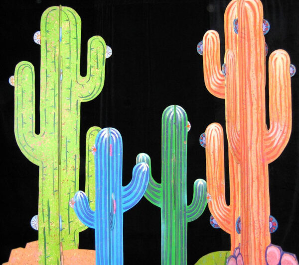 A group of Cactus Cutouts stands in front of a black background.